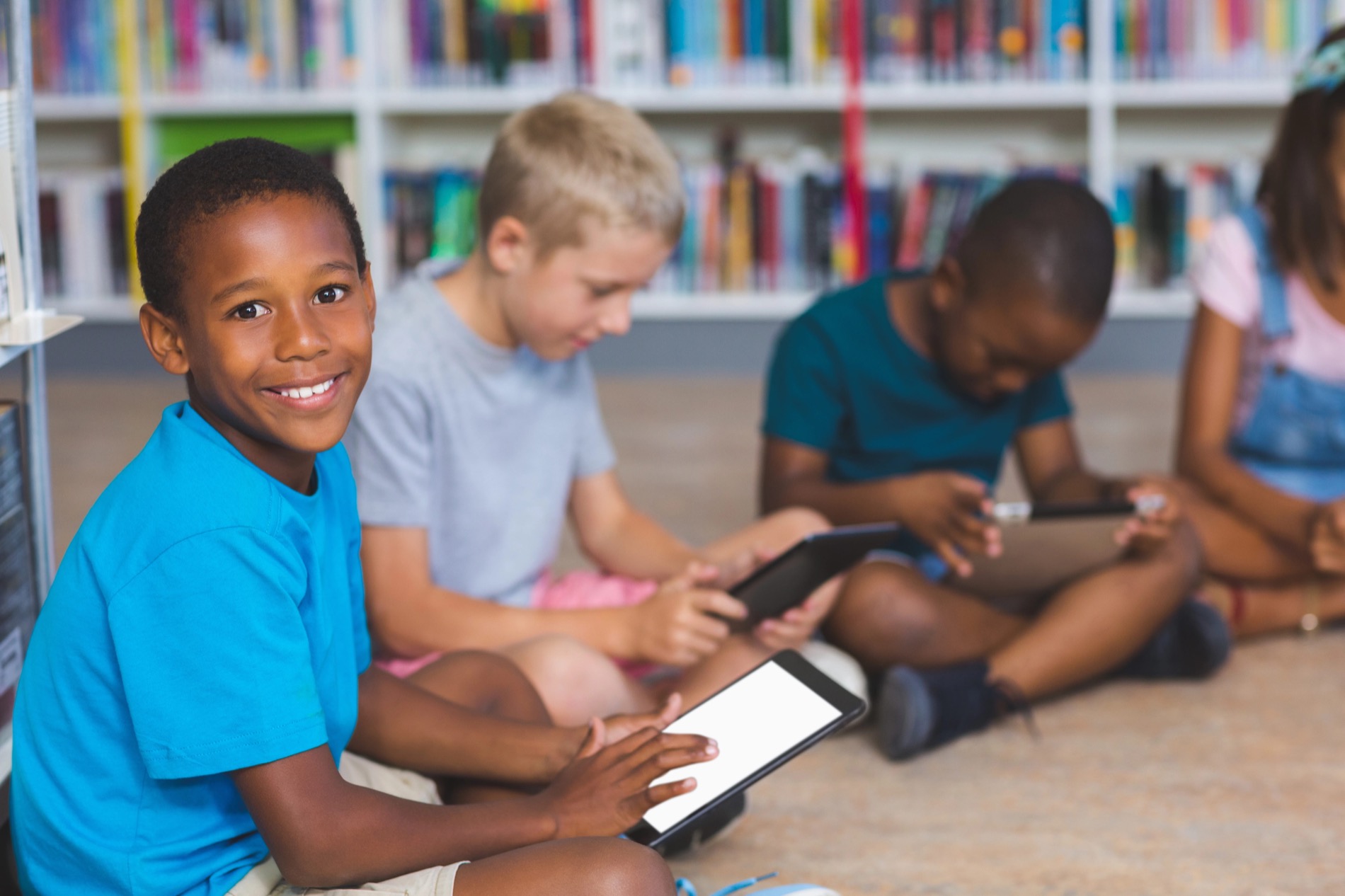 Students reading on tablets in the library